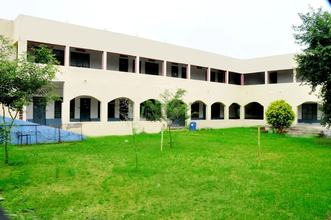 Green courtyard with the campus building